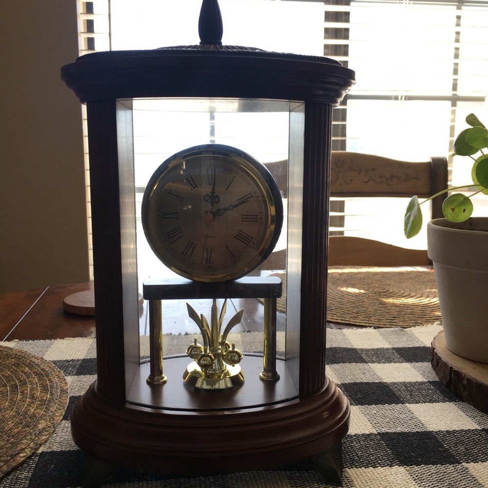 Cherry red wood clock that rotates the little gold balls spin the bottom